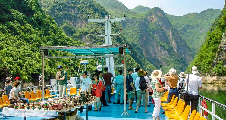 Tourists on a boat enjoying the view of river gorges.
