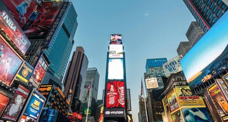 Bustling Times Square filled with people, lights, and advertisements.