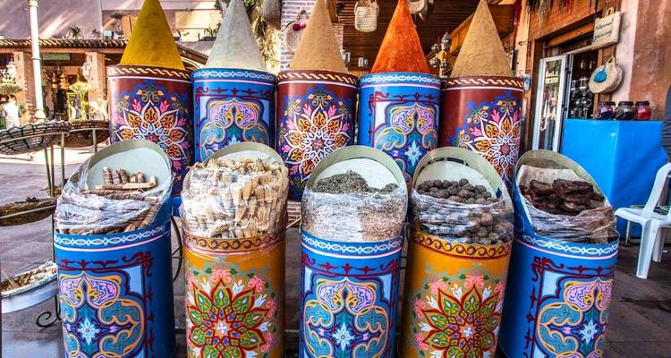 Colorful market display with spices and products.