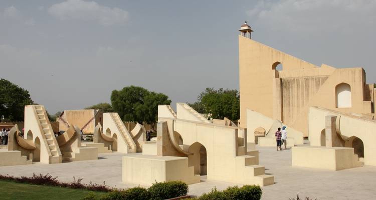 An architectural structure with geometric designs in an open plaza.