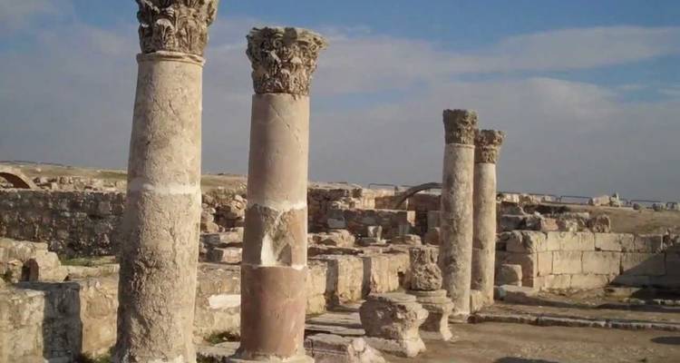 Ancient Roman columns against a clear blue sky.