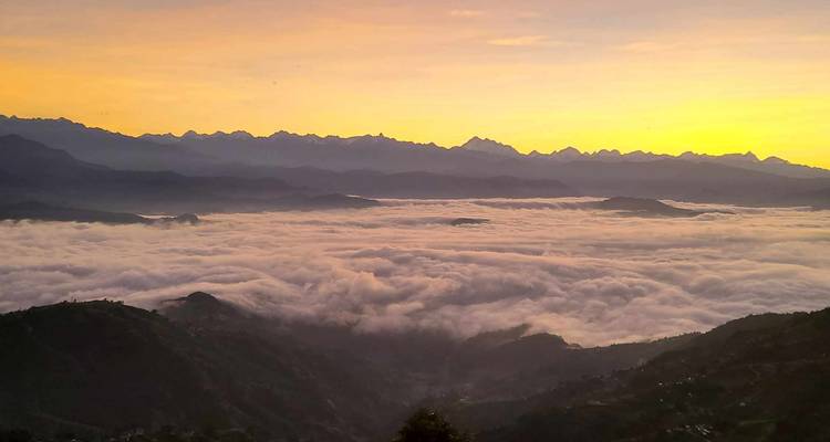 Stunning sunrise over mountains with a sea of clouds.