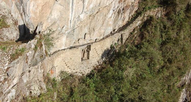 Stone path carved into the mountain with greenery.