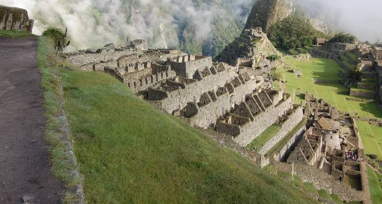 Terraces and stone structures of Machu Picchu seen from above.