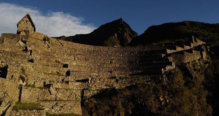 Incan terraces with a house overlooking the landscape.