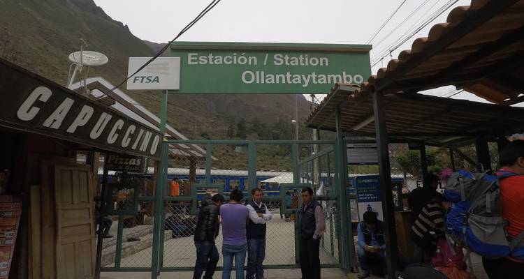 Train station in Ollantaytambo with people waiting.