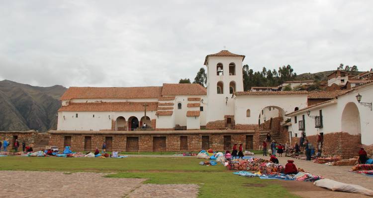 Market scene in front of a large church with people browsing.