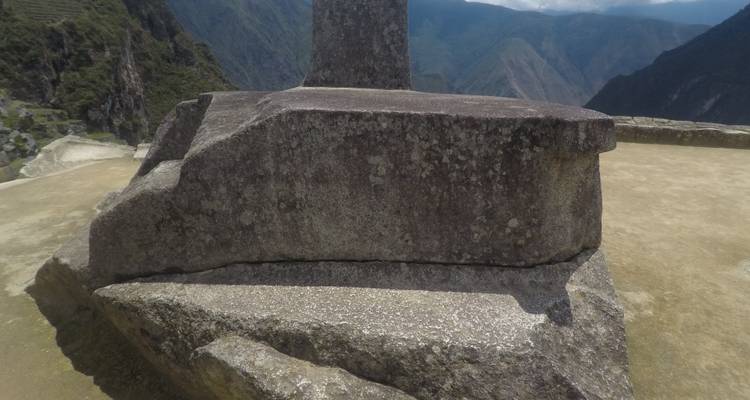 Large stone structure with a view of distant mountains.