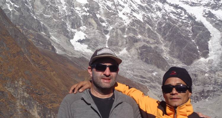 Twee toeristen die poseren voor een bergketen.