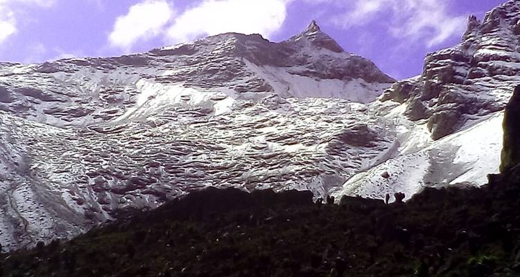 Snow-covered mountains under a blue sky.