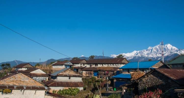 Traditional village rooftops with mountainous backdrop