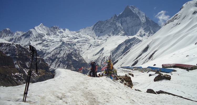 Snow-covered mountains with hikers in Nepal.