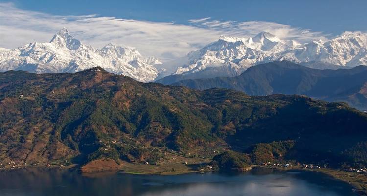 Scenic view of snow-covered mountains and a valley.