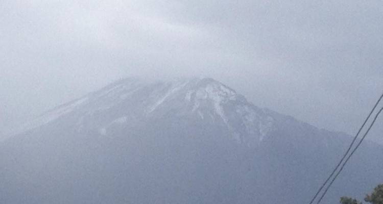 Mountain partially covered by clouds.
