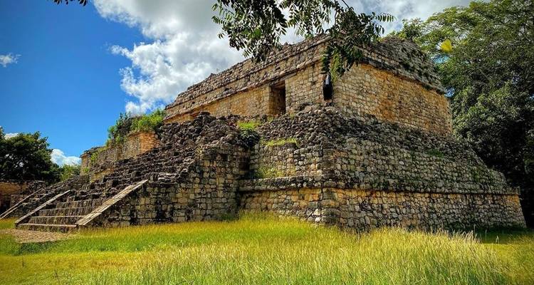 Ancient stone ruins in lush green surroundings.