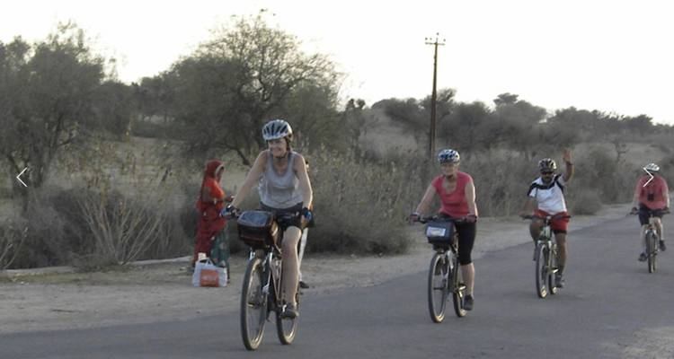 Group of cyclists riding on a rural road.