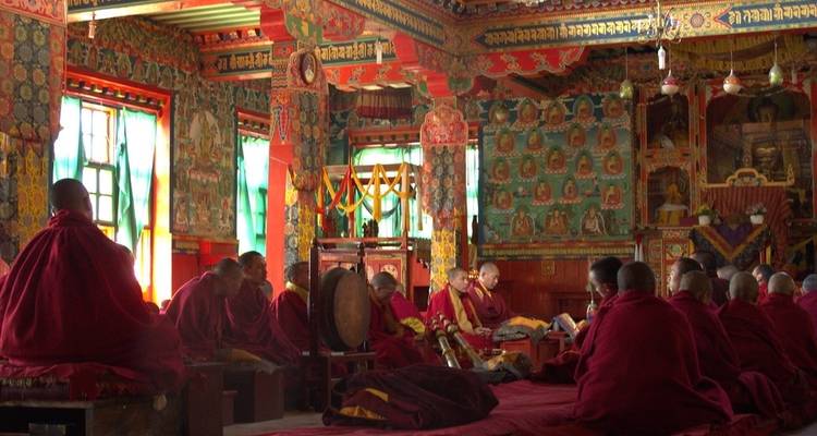 Monks participating in a ceremony inside a temple.