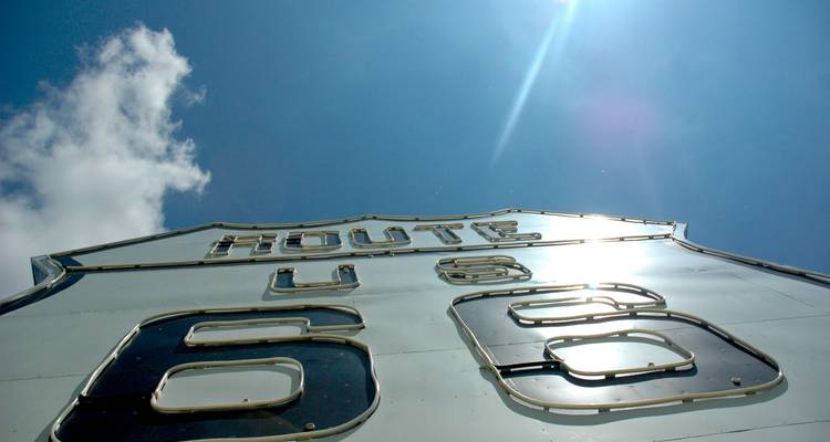 Route 66 highway sign with a clear sky.