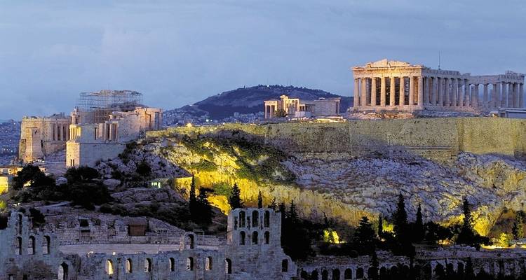 Twilight view of the Acropolis with the illuminated Parthenon crowning the rocky hill above Athens.