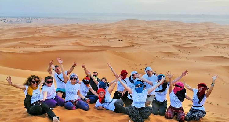 Group posing in the Moroccan desert.