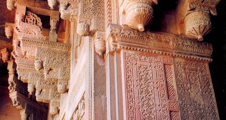 Close-up of intricately carved stonework on a historic building.