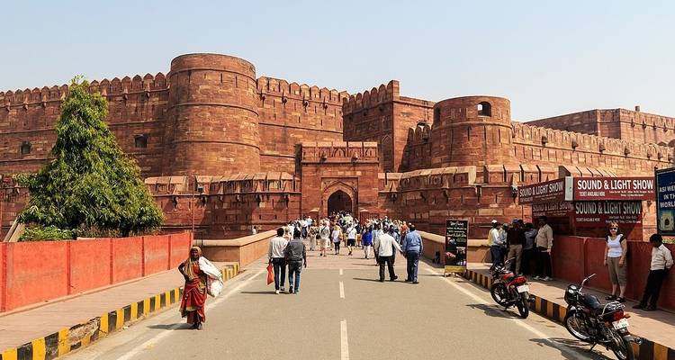 Agra Fort with visitors walking along the entrance path.
