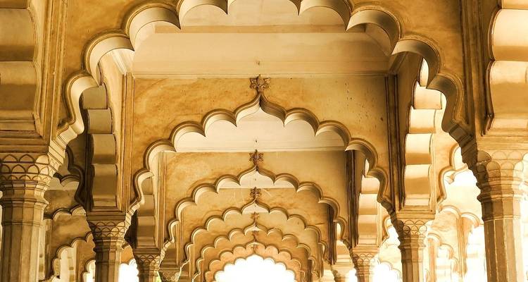 Arched corridors with intricate patterns in a palace.