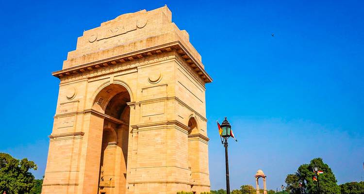 India Gate standing prominently against a clear blue sky.