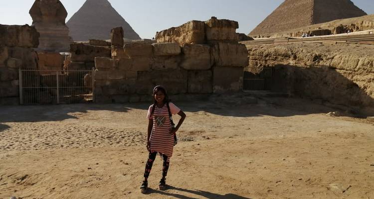 Child posing in front of ancient ruins.
