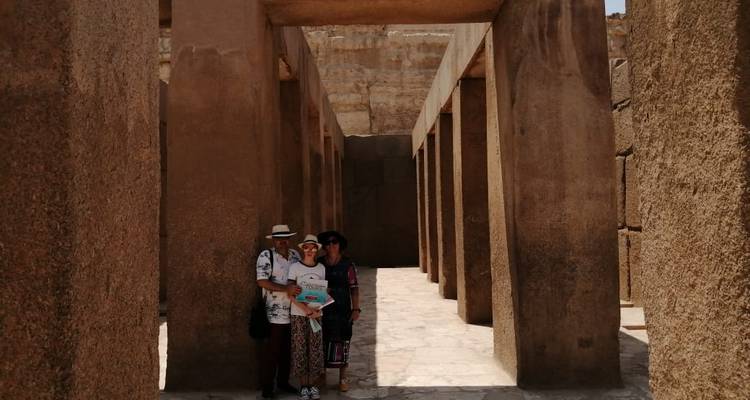 Family posing among ancient stone columns.