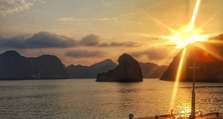 Sunset over rocky islands at sea.