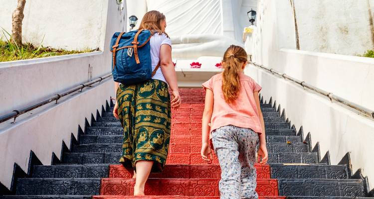 Two people climbing a colorful staircase