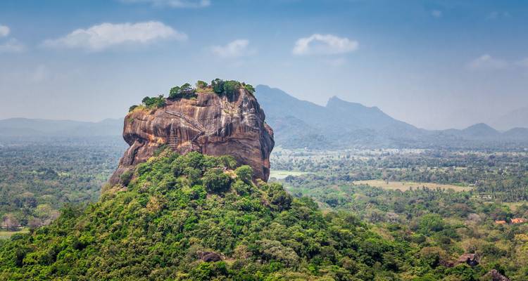 Sigiriya rock with lush forest surrounding it