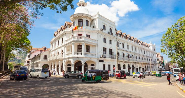 Colonial-style building in a city center with traffic