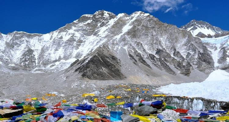 Colorful prayer flags with snowy mountains.