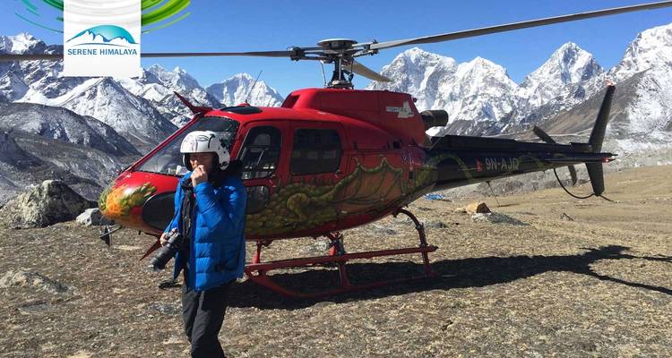 A helicopter and a person with mountains in the background.