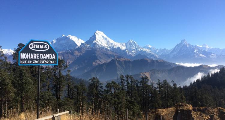 Schilderachtig uitzicht op met sneeuw bedekte bergen met een bord voor Mohare Danda.