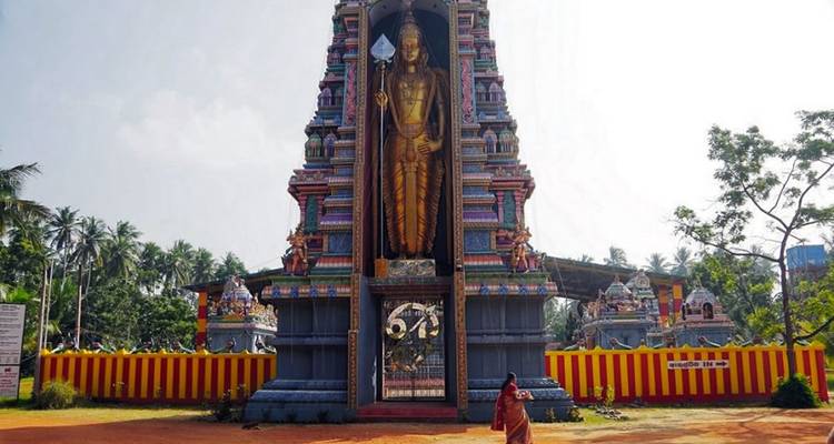 Large religious statue and temple facade.