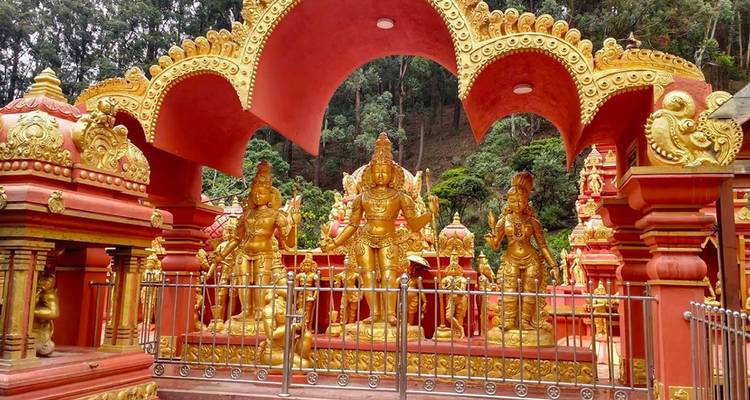 Ornate golden statues in a lush setting.
