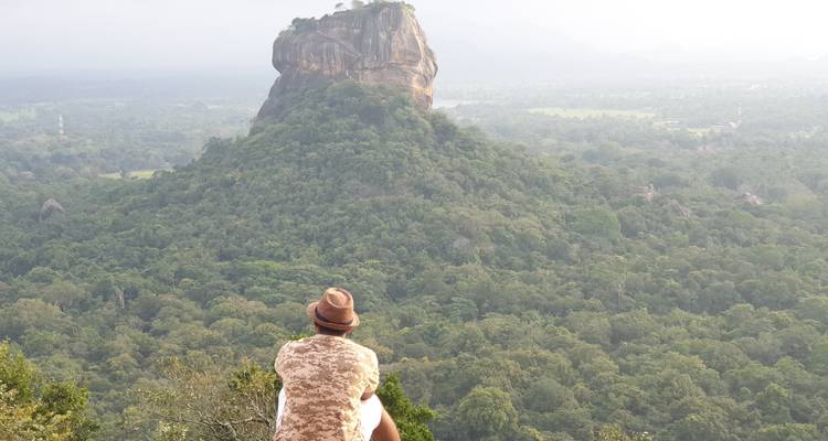 Man looking at Sigiriya Rock from a high point.
