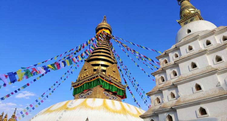 Golden stupa with colorful prayer flags.