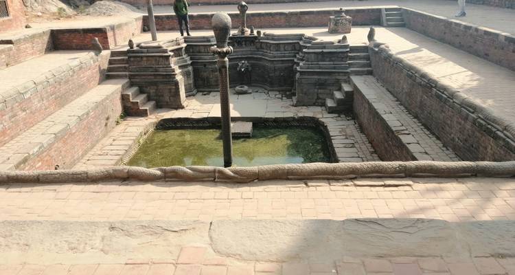 Empty stepwell with a shallow water pool.