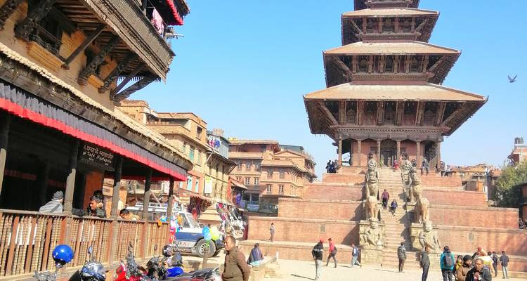 People around a historic pagoda-style temple structure.
