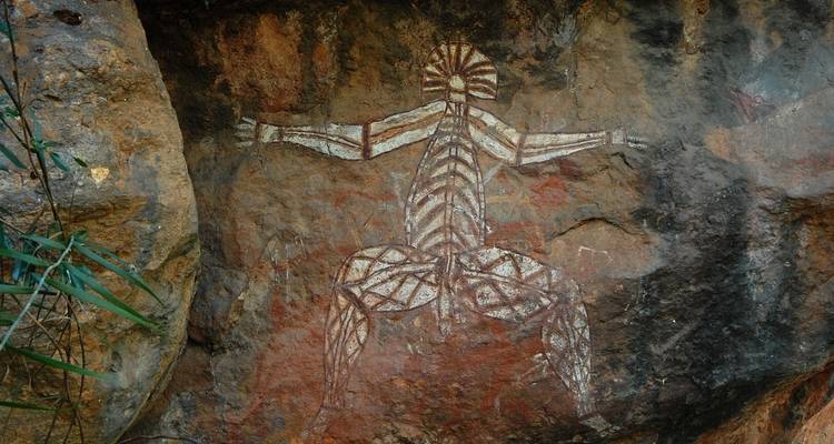 Aboriginal rock painting of a figure on a cave wall.