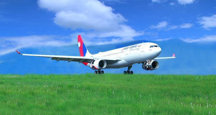 A Nepal Airlines airplane on a green field.