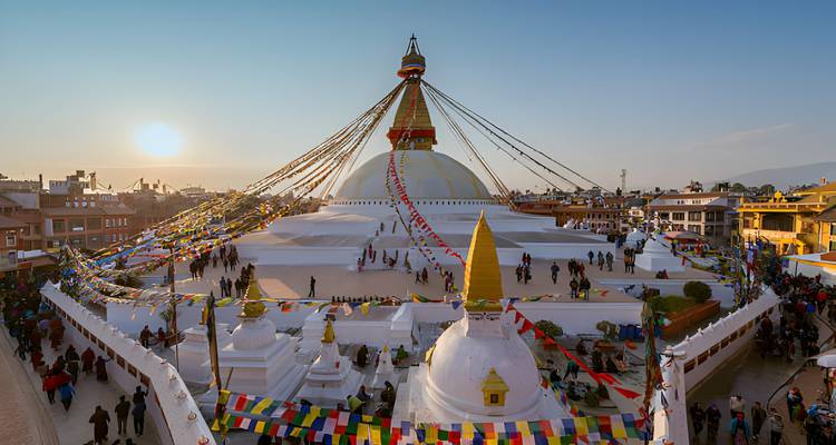 Beautiful stupa with colorful prayer flags during sunset.