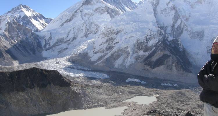 Snowy mountains with a person in the foreground.
