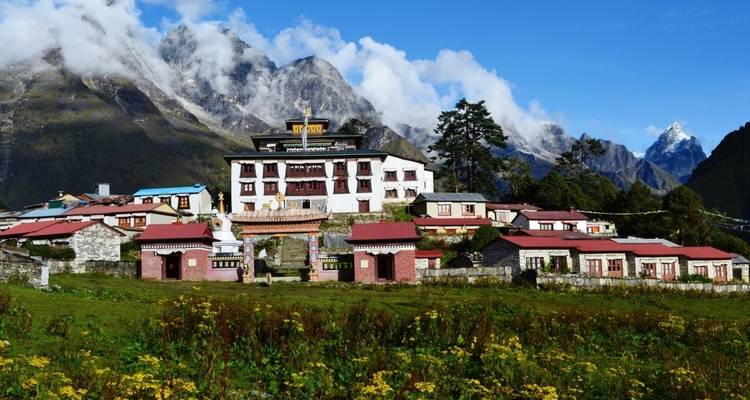 Monastery complex set against a backdrop of mountains.