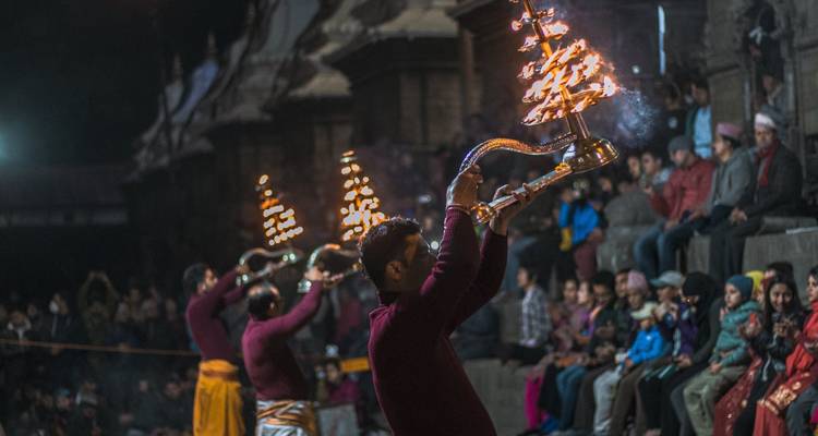 Night ceremony with people holding lit lamps