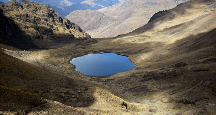 Mountain tarn surrounded by rugged rocky peaks.